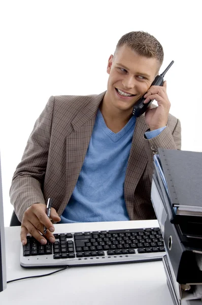 Молодий чоловік говорить по телефону, працює — стокове фото
