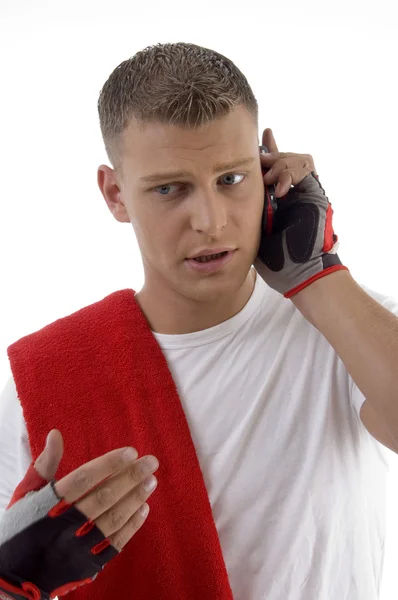Sportive man busy on mobile call — Stock Photo, Image