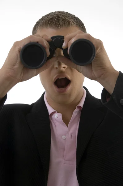 Businessman looking into binoculars — Stock Photo, Image
