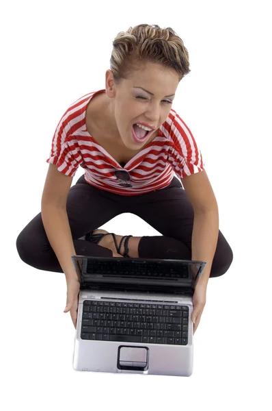 Winking beautiful model with laptop — Stock Photo, Image