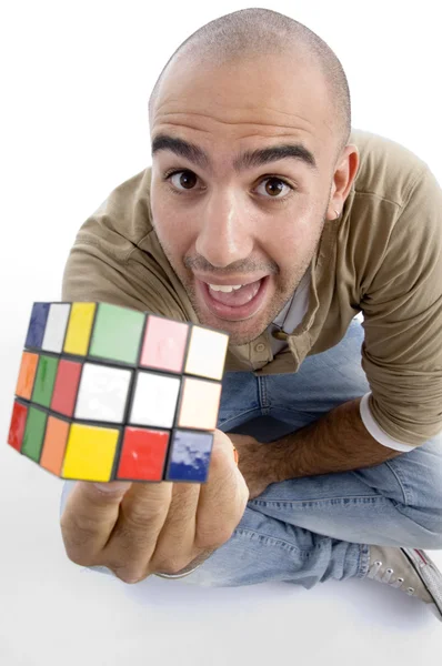Jovem mostrando cubo de quebra-cabeça para câmera — Fotografia de Stock