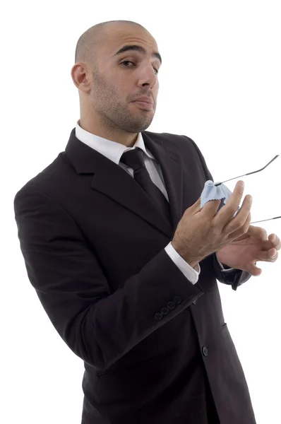 Corporate man wiping off his eyeglasses — Stock Photo, Image