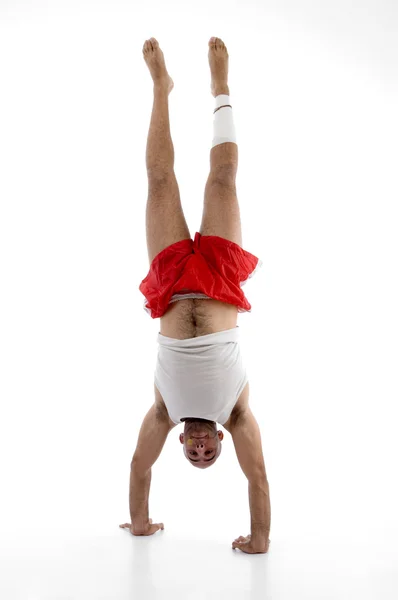 Muscular man doing hand stand — Stock Photo, Image