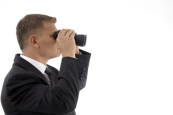 Businessman using a pair of binoculars — Stock Photo, Image