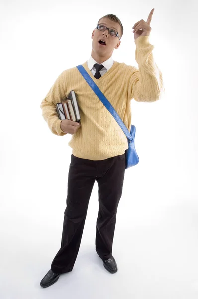 Student with books pointing upwards — Stock Photo, Image