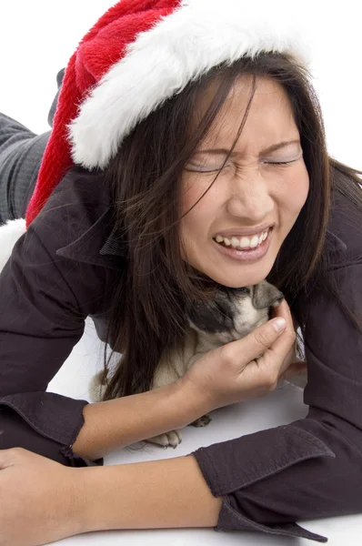 Female in christmas hat playing with pug — Stock Photo, Image