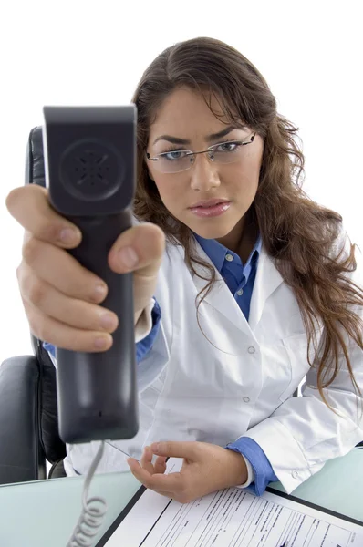 Young doctor showing phone receiver — Stock Photo, Image