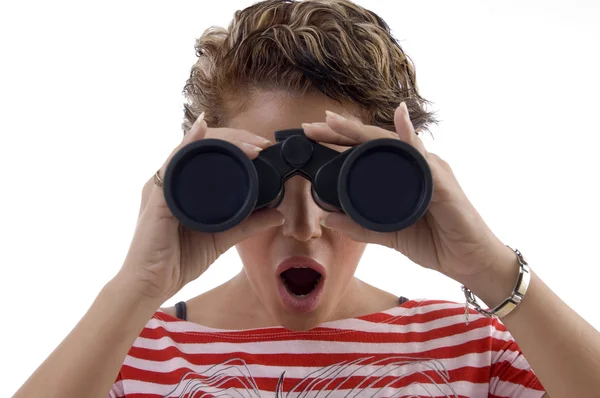 Young woman looking through binoculars Stock Photo