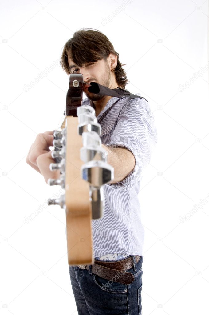 Young fellow holding guitar like a gun