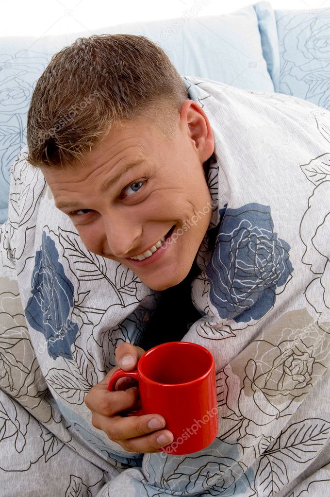 Man enjoying coffee in bed