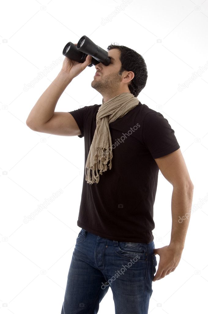 Male looking upward through binoculars