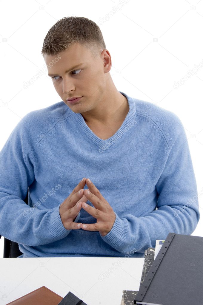 Young male sitting idle in office