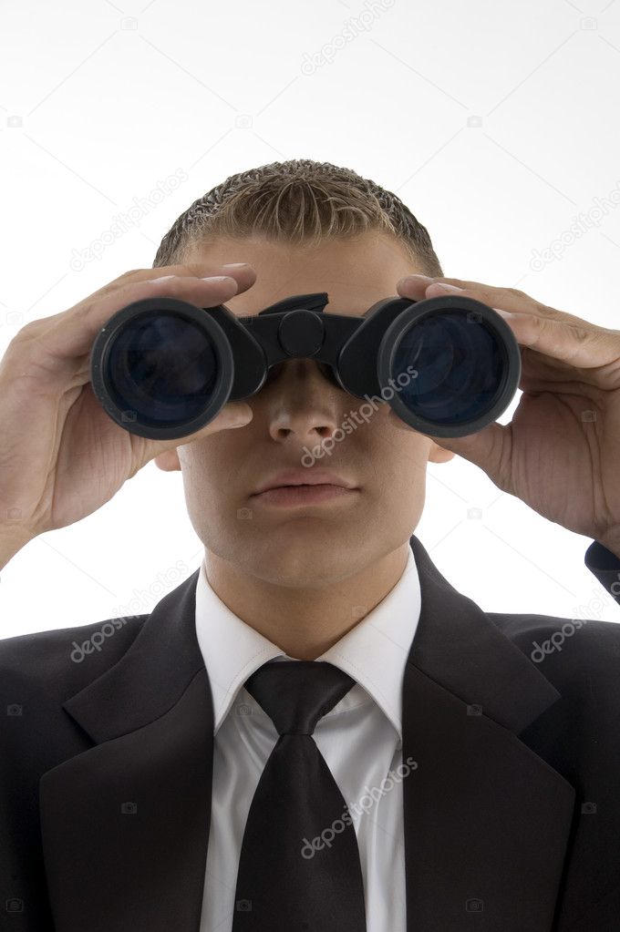 Businessman looking through binoculars