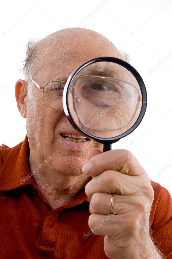 Old man looking through lens