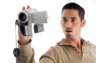 Young man looking at video from handycam clipart