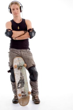 Handsome guy posing with skateboard clipart