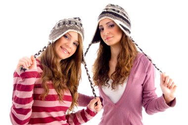 Girls stretching their woolen cap laces clipart