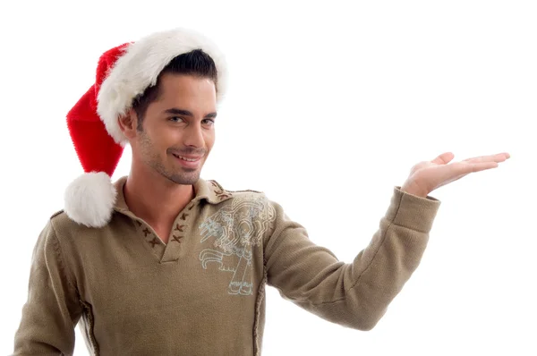 Junger Mann mit offener Handfläche in Weihnachtsmütze — Stockfoto