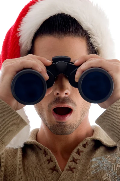 Handsome guy looking into binoculars — Stock Photo, Image