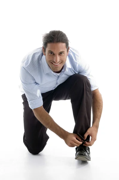 Handsome man tying his shoelace — Stock Photo, Image