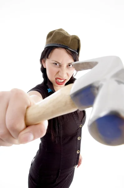 Angry young woman striking with hammer — Stock Photo, Image