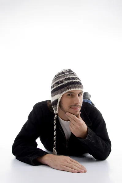 Young male lying and wearing woolen cap — Stock Photo, Image
