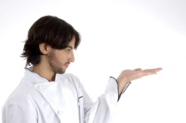 Young male chef looking at his palm — Stock Photo, Image