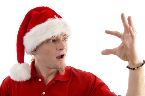 Der junge Weihnachtsmann blickt auf seine Handfläche — Stockfoto