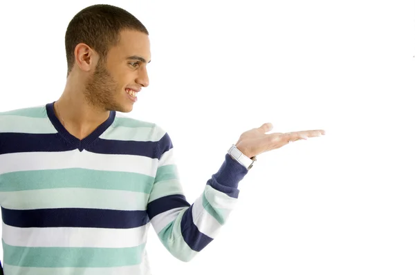 Young guy looking at his open palm — Stock Photo, Image