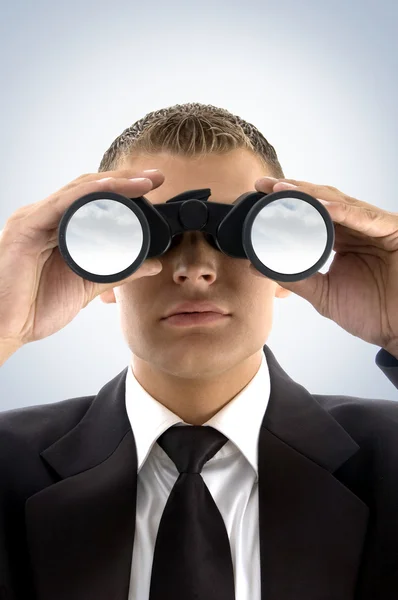 Young businessman using binoculars — Stock Photo, Image