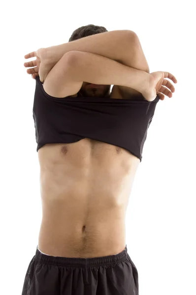 Jovem do sexo masculino, tirando suas roupas — Fotografia de Stock