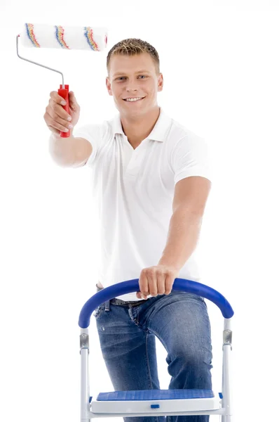 Young man holding paint roller — Stock Photo, Image
