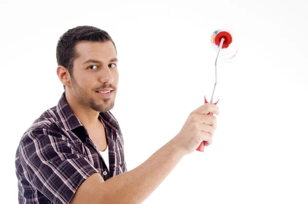 Young male holding roller brush — Stock Photo, Image