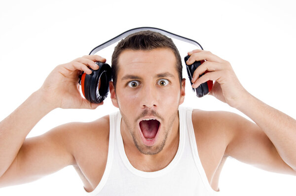 Astonished male listening music