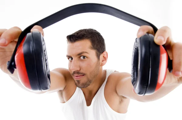 Handsome male showing headphones — Stock Photo, Image