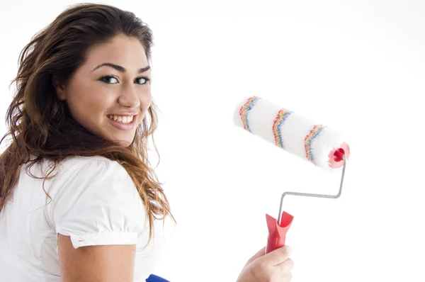 Young female holding paint roller — Stock Photo, Image