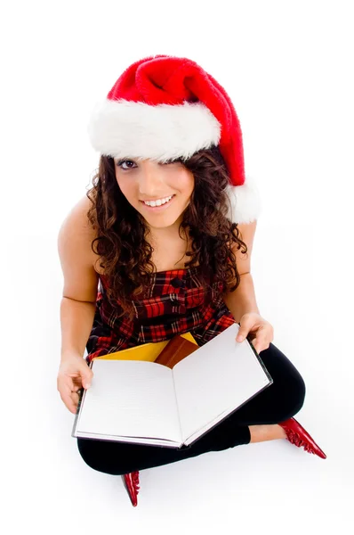 Female with christmas hat and books — Stock Photo, Image