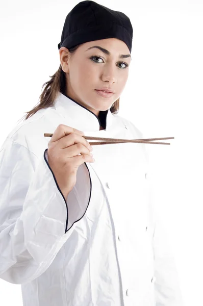 Female chef holding chopsticks — Stockfoto