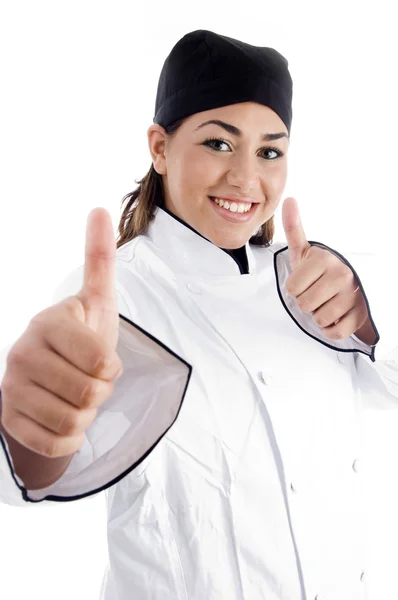 Úspěšná žena šéfkuchař ukazuje palec — Stock fotografie