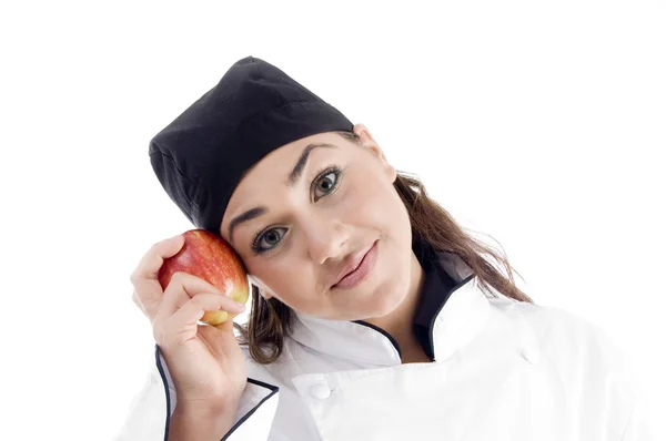 Piękna kobieta kucharz trzyma jabłko — Zdjęcie stockowe