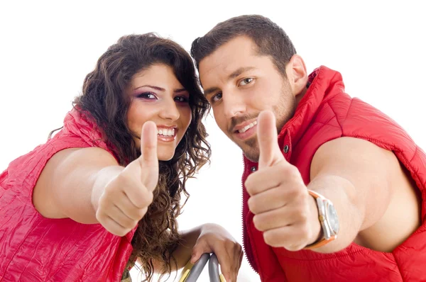 Cheerful young couple showing thumbs up — Stock Photo, Image