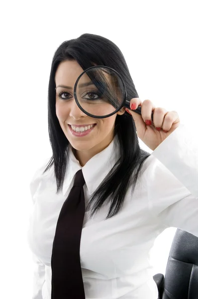 Young boss looking through magnifier — Stock Photo, Image