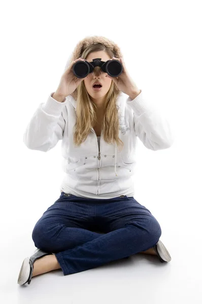 Young female watching into binoculars — Stock Photo, Image