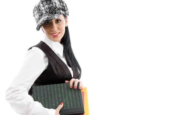 Female student wearing cap holding books — Stock Photo, Image
