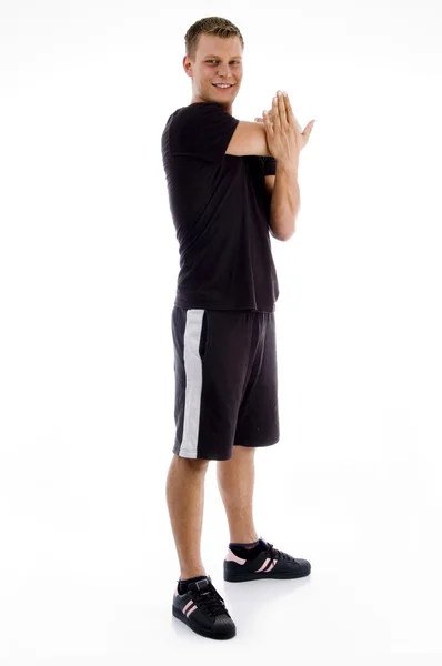 Jovem do sexo masculino esticando os braços — Fotografia de Stock