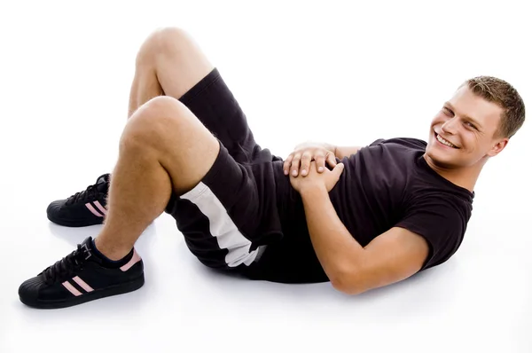 Handsome young guy doing crunches — Stock Photo, Image