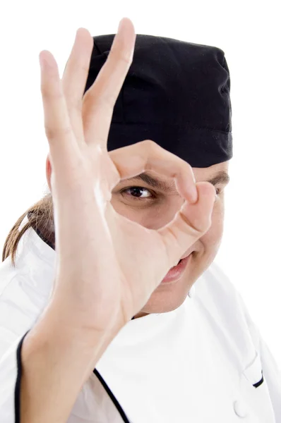 Chef mirando a través del agujero del dedo — Foto de Stock