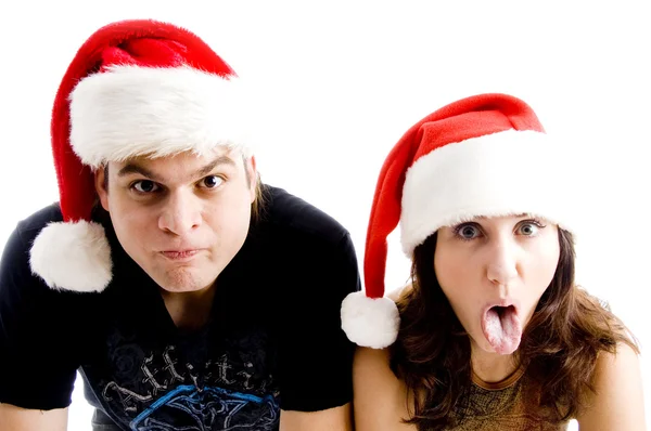 Пара с рождественской шляпой, корчащей рожи — стоковое фото