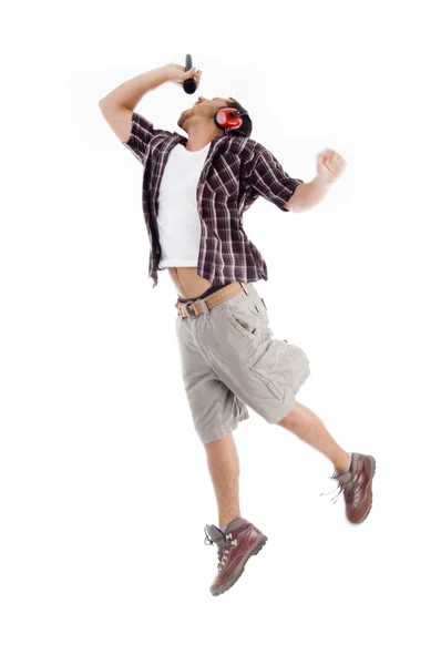 Male jumping high in air and singing — Stock Photo, Image