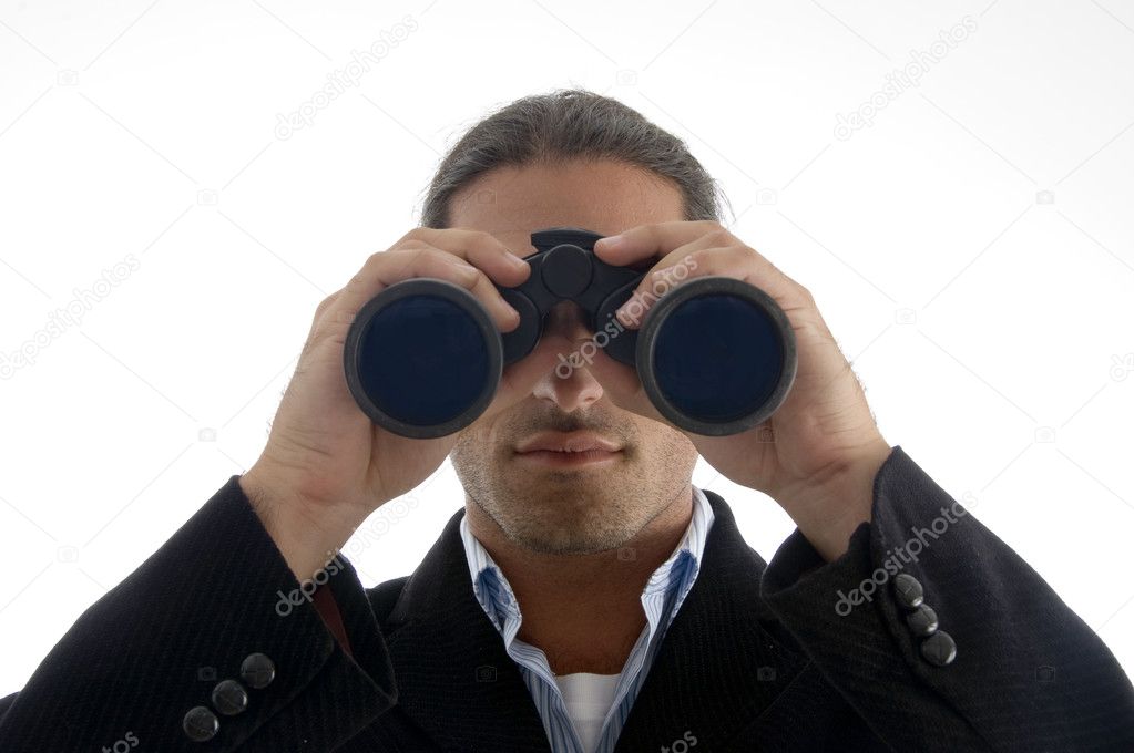 Executive looking through binoculars